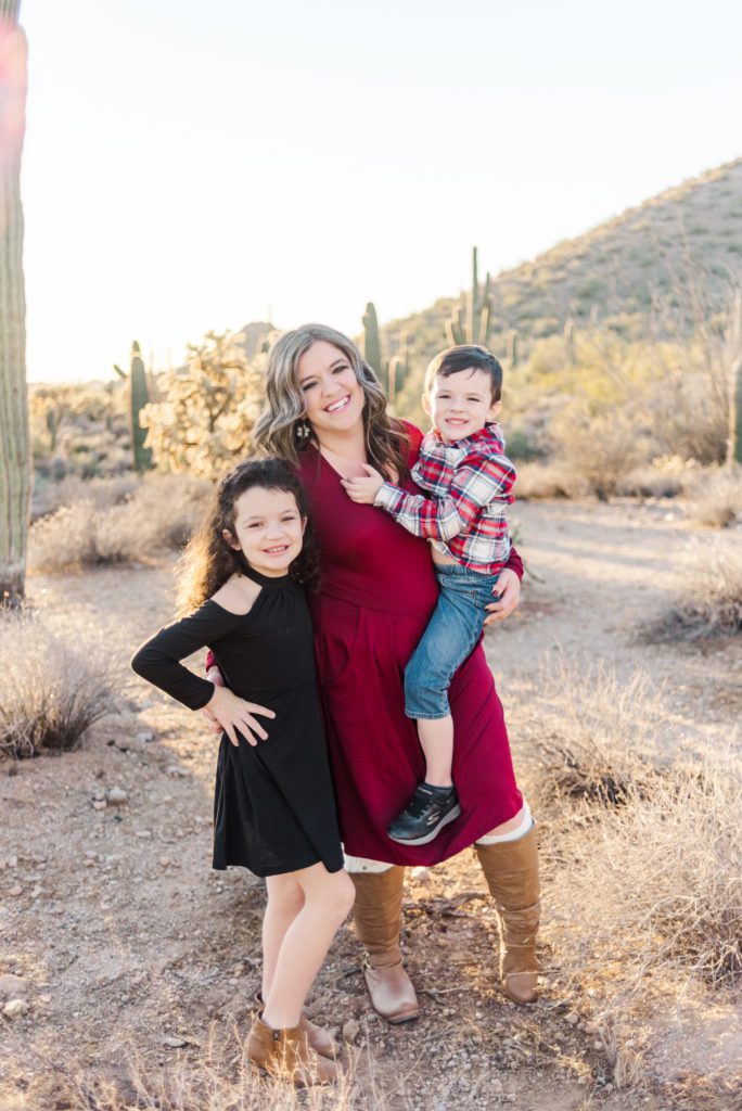 Mom holder her son with other arm wrapped around daughter standing outside in the Arizona Desert